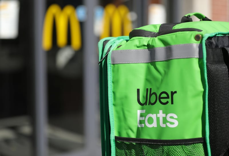 An Uber Eats food delivery courier's backpack is seen in from of a fast food restaurant as the spread of coronavirus disease (COVID-19) continues in Amsterdam, Netherlands March 25, 2020. REUTERS/Eva Plevier