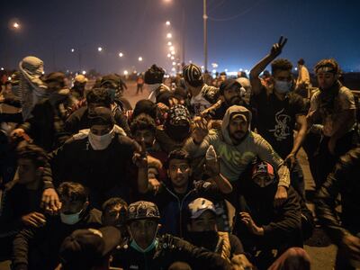 Protestors gather for a group photo on Muhammad Al Qasim bridge, capturing the moment live rounds were fired in their direction. Luke Pierce / The National