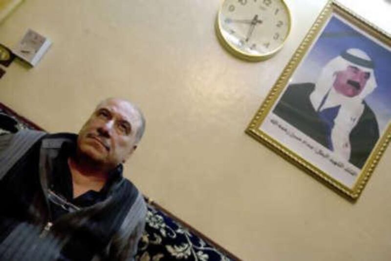 Muayed Abdulkadir, editor of the Iraqi resistance newspaper Al Saut, sits in his office in Damascus with a poster of Saddam Hussein on the wall.