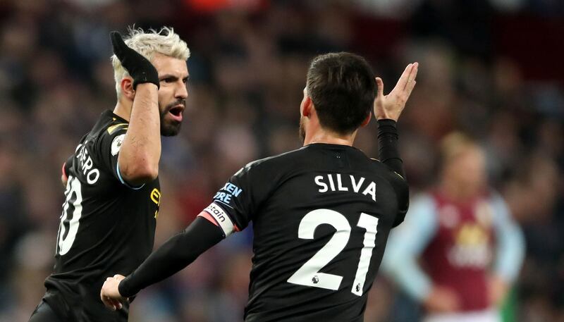 Manchester City's Sergio Aguero, left, celebrates scoring his side's third goal at Villa Park. PA