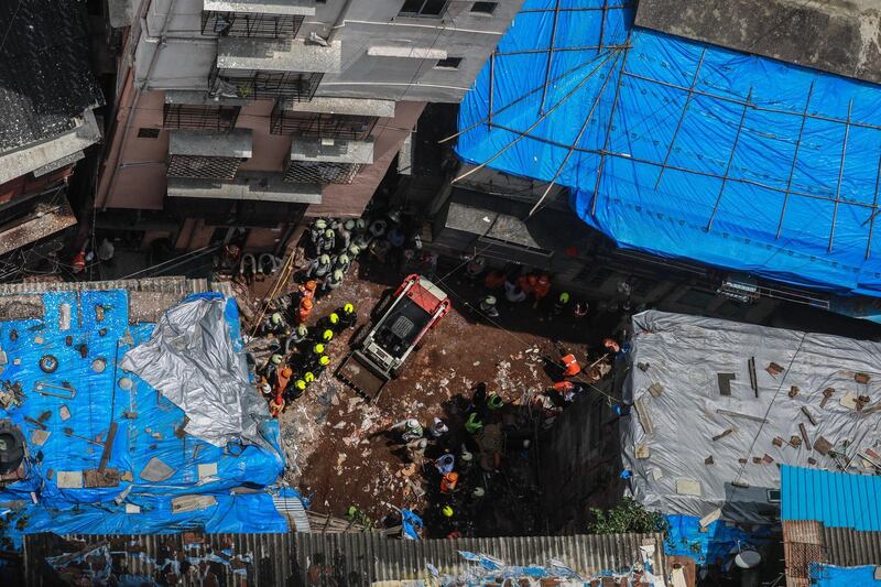 epa07721884 Rescuers work at the site of collapsed building in Dongri area of Mumbai, India, 17 July 2019. According to reports, at least ten people were killed and several others feared trapped when a four-story residential building collapsed on 16 July.  EPA/DIVYAKANT SOLANKI