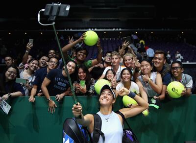 SINGAPORE - OCTOBER 25:  Caroline Garcia of France takes a selfie with fans as she celebrates victory in her singles match against Elina Svitolina of Ukraine during day 4 of the BNP Paribas WTA Finals Singapore presented by SC Global at Singapore Sports Hub on October 25, 2017 in Singapore.  (Photo by Julian Finney/Getty Images for WTA)