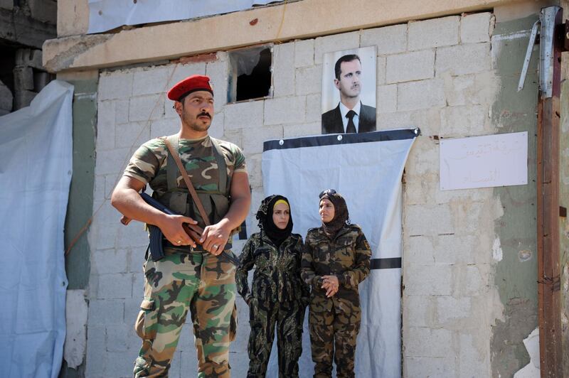 Syrian soldiers stand guard outside the Suran crossing point, close to the Turkish border.  AFP