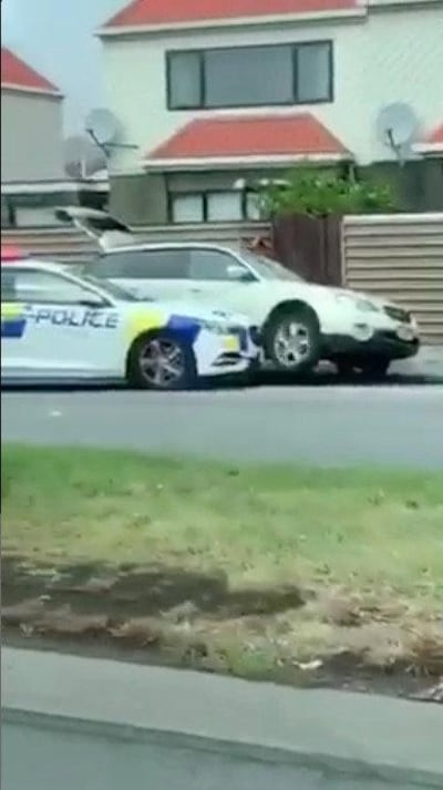 A police car blocks the car of a suspect following shootings at two mosques in Christchurch, New Zealand March 15, 2019, in this still image obtained from a social media video. Courtesy of Twitter @ROBERT22041432/Social Media via REUTERS. ATTENTION EDITORS - THIS IMAGE HAS BEEN SUPPLIED BY A THIRD PARTY. MANDATORY CREDIT “TWITTER / @ROBERT22041432”. NO RESALES. NO ARCHIVES.