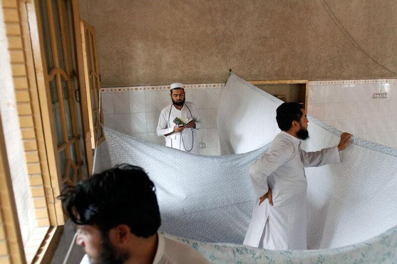 An Afghan Muslim, who lives and prays in isolation in a mosque during Itikaf, reads from the Quran in the city of Jalalabad, east of Kabul, Afghanistan. Rahmat Gul / AP Photo