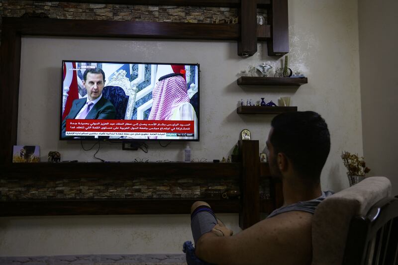 Watching Mr Al Assad on TV in Damascus on the eve of the summit. AFP
