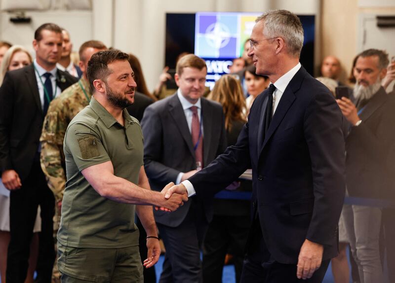Mr Stoltenberg shakes hands with Mr Zelenskyy ahead of their joint press conference. AFP