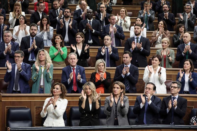 Members of the government applaud in Madrid as Mr Sanchez delivers his speech. AFP