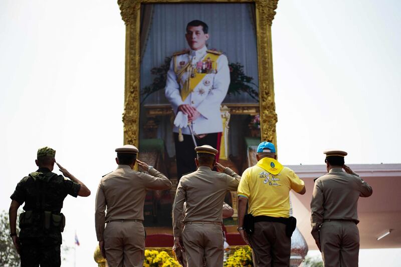 Thailand's Prime Minister Prayut Chan-O-Cha, Royal Thai Army Commander-in-Chief Apirat Kongsompong  and others salute in front of a portrait of King Maha Vajiralongkorn in Lopburi.  AFP