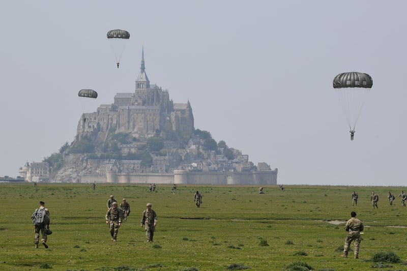 US paratroopers walk back after jumping over Le Mont-Saint-Michel, north-western France less than three weeks before the 75th anniversary of the D-Day landings.   AFP