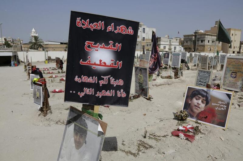 Tributes recalll the victims of a suicide bombing of a Shia mosque, at a cemetery in al-Qudeeh, Saudi Arabia. (AP Photo/Hasan Jamali)