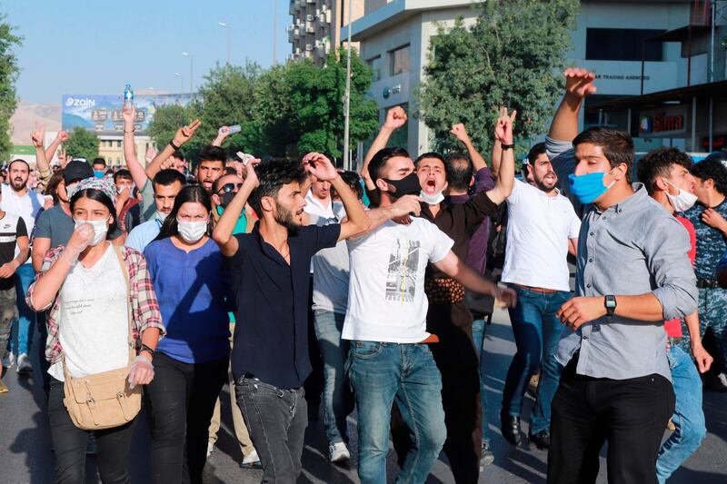 Iraqi kurds, some of them wearing protective masks due to COVID-19, march during a demonstration to denounce the Turkish assault in northern Iraq, in Sulaimaniyah city, in the Kurdish autonomous region of northern Iraq, on June 18, 2020. Turkey launched a rare ground assault into northern Iraq on June 17, deploying special forces against rebels from the Kurdistan Workers' Party (PKK) which is blacklisted by Ankara as a "terrorist" group. Baghdad demanded Ankara immediately halt its assault in northern Iraq, where Turkish special forces and helicopters have been targeting Kurdish rebel hideouts. / AFP / Shwan MOHAMMED
