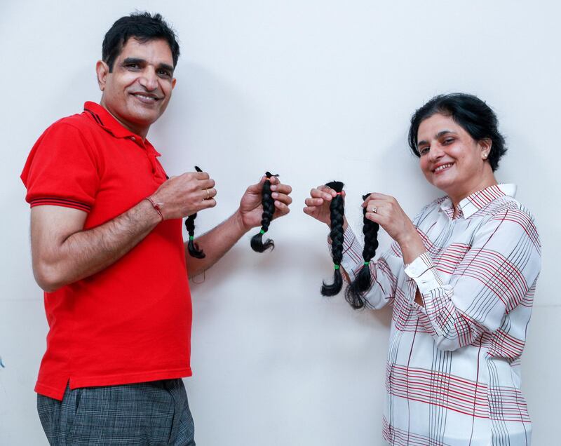 Abu Dhabi, United Arab Emirates, February 4, 2021.  Dr Yogesh Shastri, a gastroenterologist at NMC Speciality Hospital Abu Dhabi, together with his wife Sarika have grown their hair for two years to donate to a wig making charity to help paediatric cancer patients.  The couple after getting proper haircuts.
Victor Besa/The National
Section:  NA
Reporter:  Gillian Duncan