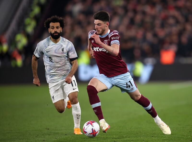 Liverpool's Mohamed Salah and West Ham United's Declan Rice battle. PA