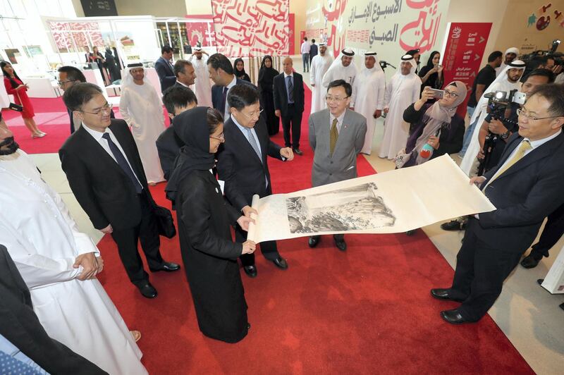 Abu Dhabi, United Arab Emirates - July 15, 2018: Week of UAE/China events to build up the State Visit of Xi Jinping. A cultural day with Noura Al Kaabi is presented with a scroll by Chinese Minister Wang Xiaohui (M) and Ni Jian (UAE Chinese ambassador). Sunday, July 15th, 2018 in Manarat Al Saadiyat, Abu Dhabi. Chris Whiteoak / The National