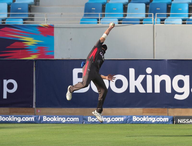 Dubai, United Arab Emirates - October 30, 2019: Rameez Shahzad of the UAE catches George Munsey of Scotland off the bowling of Ahmed Raza during the game between the UAE and Scotland in the World Cup Qualifier in the Dubai international cricket stadium. Wednesday the 30th of October 2019. Sports City, Dubai. Chris Whiteoak / The National