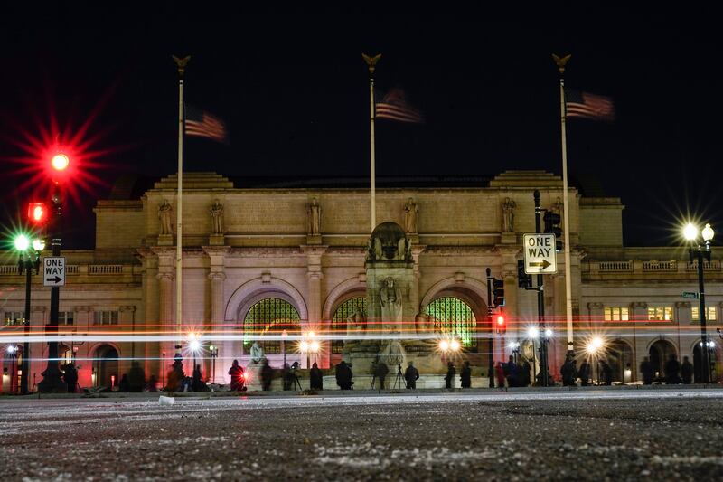 Birdwatchers set up in front of Union Station in Washington, US Friday, hoping for a glimpse of a rare snowy owl that has been flying around Washington's Capitol Hill neighbourhood.  AP