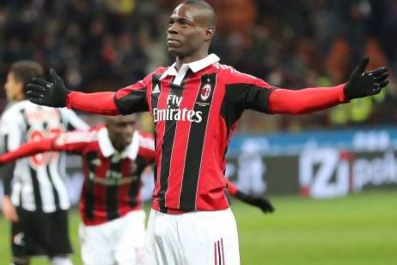 AC Milan forward Mario Balotelli celebrates after scored both goals for his team in a 2-1 win over Udinese on Sunday. Antonio Calanni / AP photo