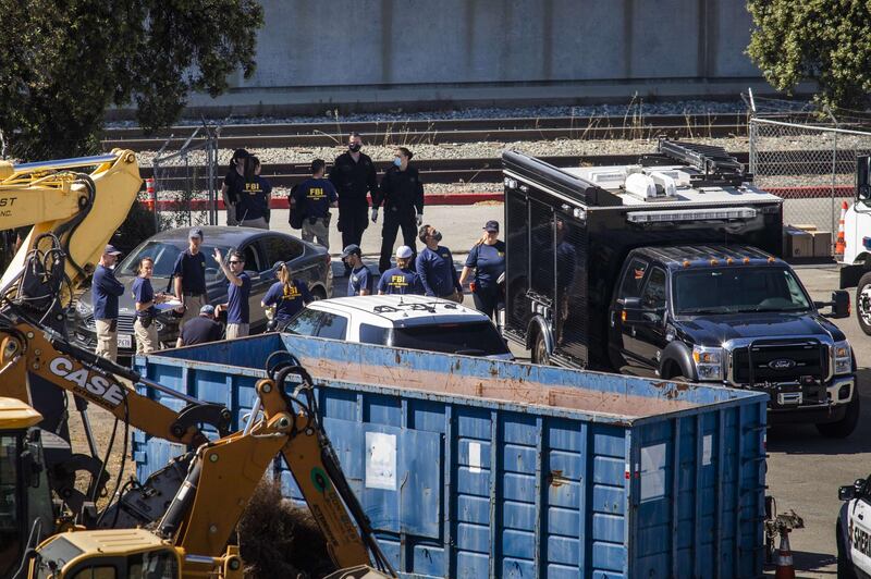 Investigators work the scene of a mass shooting at the Valley Transportation Authority (VTA) light-rail yard in San Jose, California. A VTA employee opened fire at the yard, with preliminary reports indicating nine people dead including the gunman. AFP