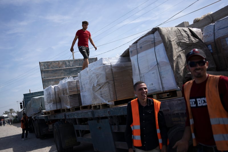 Lorries carrying humanitarian aid enter the Gaza Strip from Egypt, at the Rafah border, on Saturday. AP