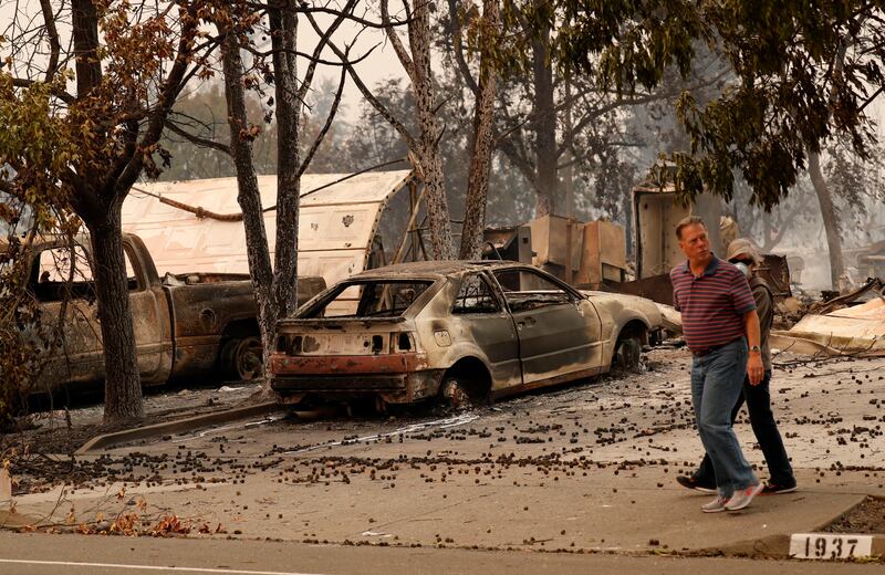 Residents walk through their destroyed neighbourhood in Santa Rosa. John G Mabanglo / EPA