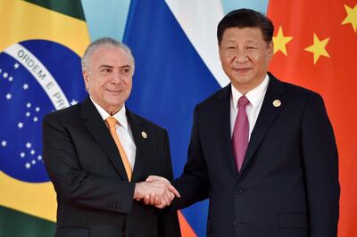 (FILES) In this file picture taken on September 4, 2017 Chinese President Xi Jinping (R) and Brazilian President Michel Temer shake hands before the group photo during the BRICS Summit at the Xiamen International Conference and Exhibition Center in Xiamen, southeastern China's Fujian Province.  China, Brazil's main trading partner, multiplies and diversifies its investments in the largest Latin American economy in 2018. / AFP / POOL / Kenzaburo FUKUHARA
