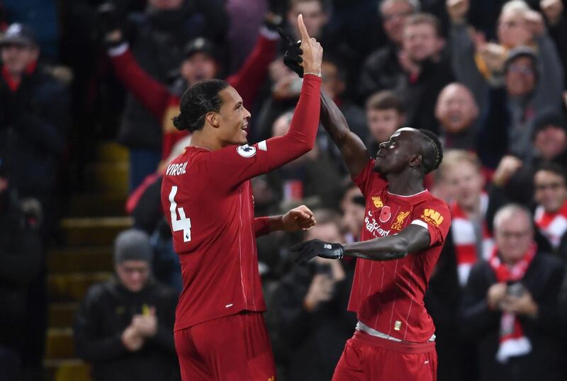 Sadio Mane of Liverpool celebrates after scoring his team's third goal against Manchester City with teammate Virgil van Dijk at Anfield on Sunday. Getty Images