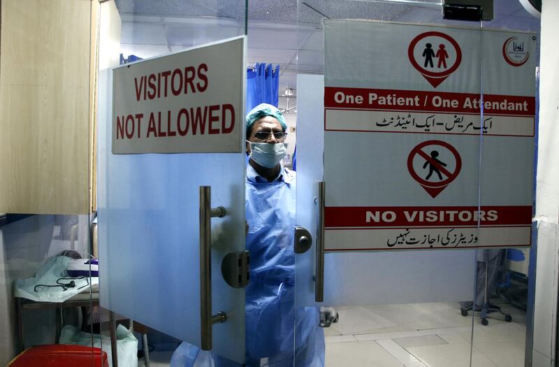 A member of a paramedical staff is leaving the emergency ward of Alkhidmat Raazi Hospital in Islamabad that is run by Alkhidmat Foundation which provides free of cost oxygen essentials to COVID-19 patients at their homes. Imran Mukhtar/ The National 