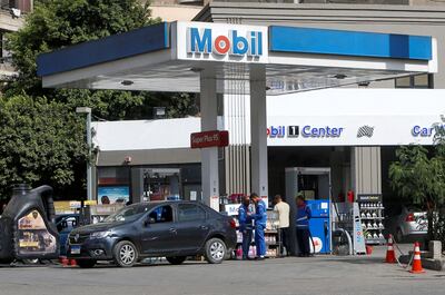 Employees fill vehicles at a Mobil petrol station in Cairo, Egypt.  Reuters 