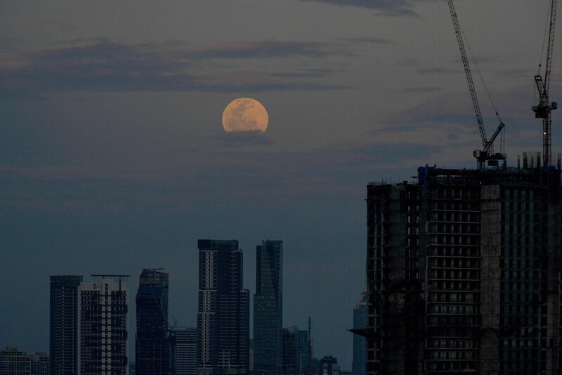 The Flower Moon rises over Manila, the Philippines, on May 5, 2023. AFP