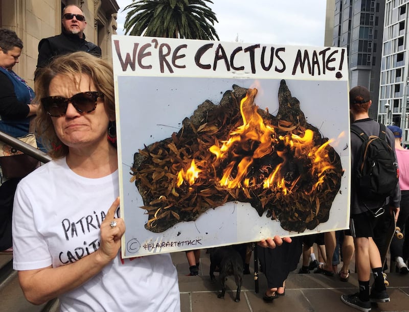 A woman holds up a sign as she takes part in a protest to call for action on climate change in Melbourne, Australia. Reuters