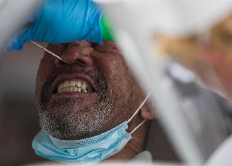 Stephen Price winces as he receives a nasal swab to test for Covid-19 in the US state of Tennessee AP