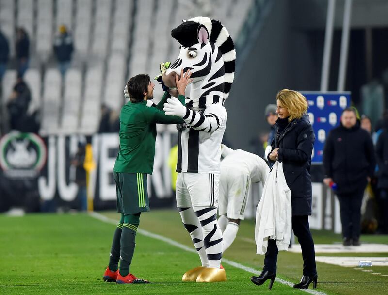 Juventus' Mattia Perin celebrates with the club mascot after the match. Reuters