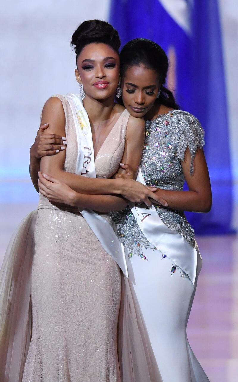 epa08072345 Miss World 2019 Miss Jamaica Toni-Ann Singh (R) shares a hug with Miss France Ophely Mezino (L) during the Miss World 2019 final in the Excel centre in London, Britain, 14 December 2019. The annual Miss World competition returns to London for its 69th year.  EPA/FACUNDO ARRIZABALAGA