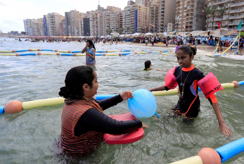 Farah swims with her sister at Al Mandara beach. Reuters