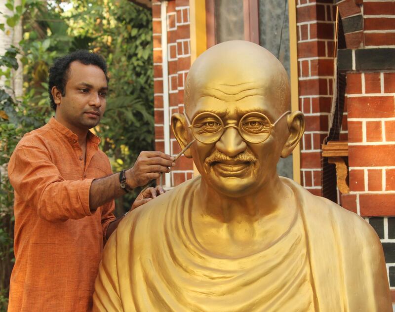 Sculptor Chithran Kunhimangalam works on a 60kg statue of Gandhi that will be installed in Abu Dhabi on Thursday. Courtesy Chithran Kunhimangalam