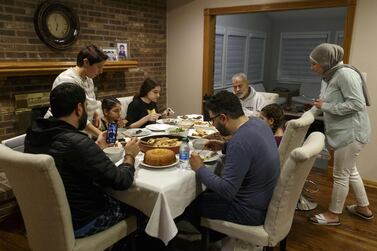 DEARBORN, MI - APRIL 24: Abbas Al Haj Ahmed talks with his cousin Adam Bazzi over a video call while their family shares a meal and breaks fast on the first full day of Ramadan on April 24, 2020 in Dearborn, Michigan. Due to the social distancing guidelines being enforced to combat the spread of the coronavirus (COVID-19) the Muslim holy month of Ramadan is going to be observed differently this year amidst the pandemic. Elaine Cromie/Getty Images/AFP == FOR NEWSPAPERS, INTERNET, TELCOS & TELEVISION USE ONLY ==