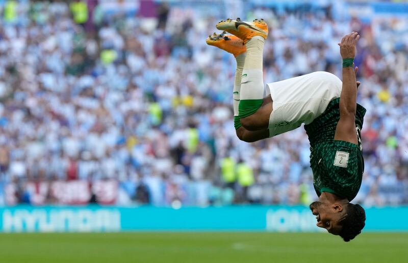 Saudi Arabia's Salem Al Dawsari is head over heels after scoring his side's second World Cup goal against Argentina in Lusail, Qatar. AP