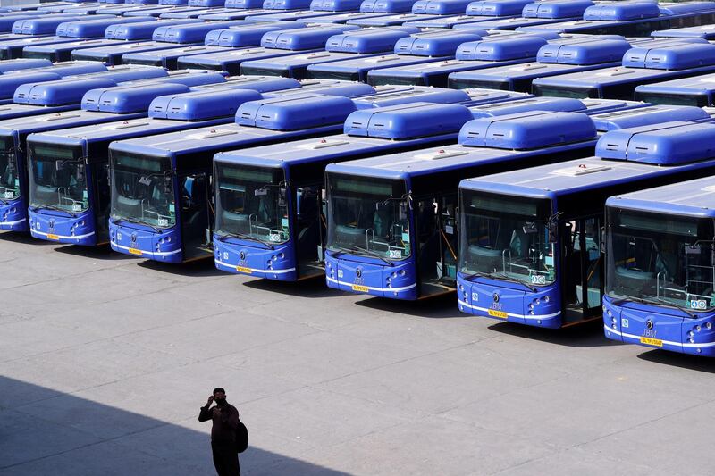 A man stands as buses are seen parked at a depot during lockdown by the authorities to limit the spreading of coronavirus disease (COVID-19), in New Delhi, India March 23, 2020. REUTERS/Adnan Abidi