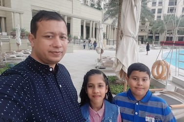 Twins Komal and Khuzaimah pictured with their father, Shefi Ulleh Niazi. Courtesy family