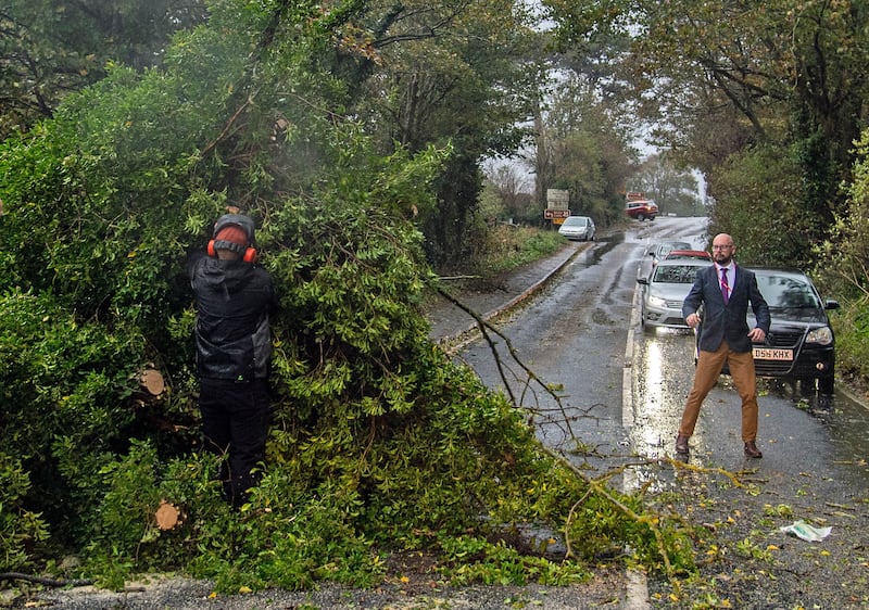 People clear fallen trees from a road in Dover, south-eastern England. EPA