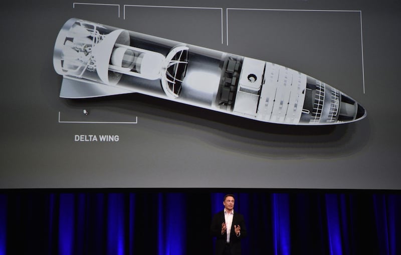 (FILES) In this file photo taken on September 28, 2017 Billionaire entrepreneur and founder of SpaceX Elon Musk speaks in below a computer generated illustration of his new rocket at the 68th International Astronautical Congress 2017 in Adelaide on September 29, 2017.  SpaceX on Thursday, September 13, 2018, announced a new plan to send a tourist around the Moon on its Big Falcon Rocket (BFR), a massive launch vehicle that is being designed to carry people to deep space. "SpaceX has signed the world's first private passenger to fly around the Moon aboard our BFR launch vehicle -- an important step toward enabling access for everyday people who dream of traveling to space," the company said on Twitter. / AFP / PETER PARKS
