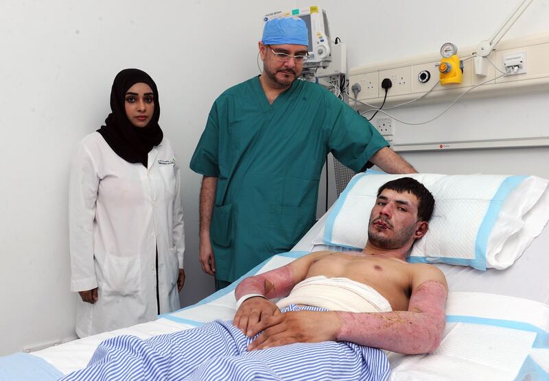 Khayal Mohammed, 20, is recovering thanks to a new technique using placenta tissue to aid healing and reduce scarring. He is pictured with Dr Marwan Al Zarouni at Rashid Hospital. DHA