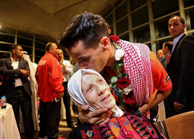 Ahmed Abughaush kisses his mother. Raad Adayleh / AP Photo