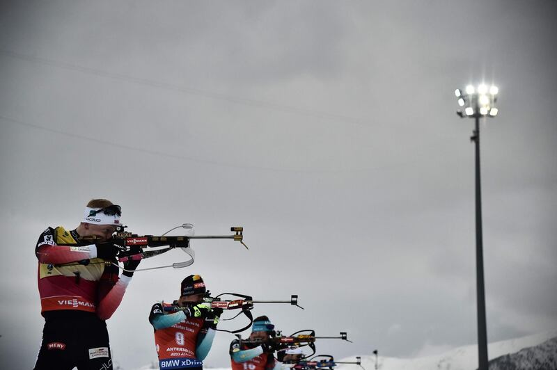 Norway's Johannes Thingnes Boe and France's Quentin Fillon Maillet compete at the shooting range during the men's 15km mass start event of the IBU Biathlon World Cup in Rasen-Antholz, Italy. AFP