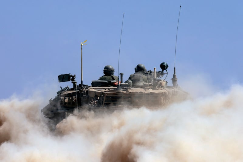 An Israeli tank travels along the border with Gaza. There is no sign yet of a pause in the war. AP