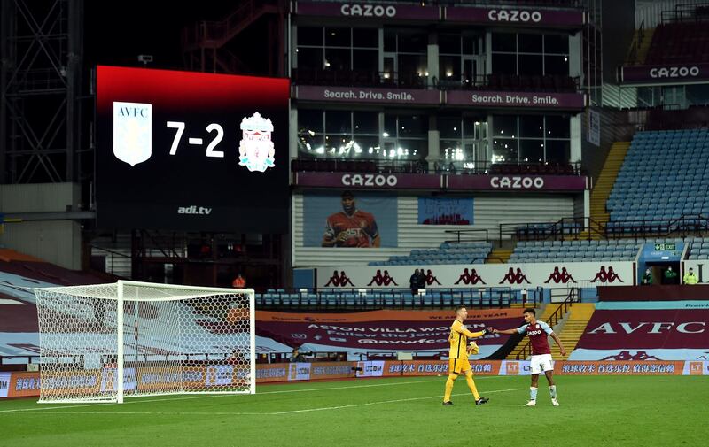 Liverpool goalkeeper Adrian and Aston Villa's Ollie Watkins fist bump in front of the big screen displaying the remarkable scoreline. PA