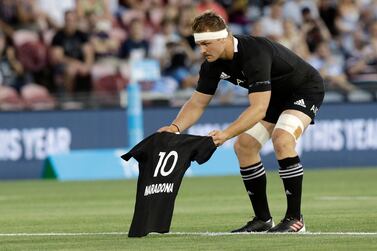 New Zealand captain Sam Cane lays All Black number 10 jersey on the pitch in memory of late Argentina soccer star Diego Maradona prior to the start Tri-Nations rugby test between Argentina and the All Blacks in Newcastle, Australia, Saturday, Nov. 28, 2020. (AP Photo/Rick Rycroft)