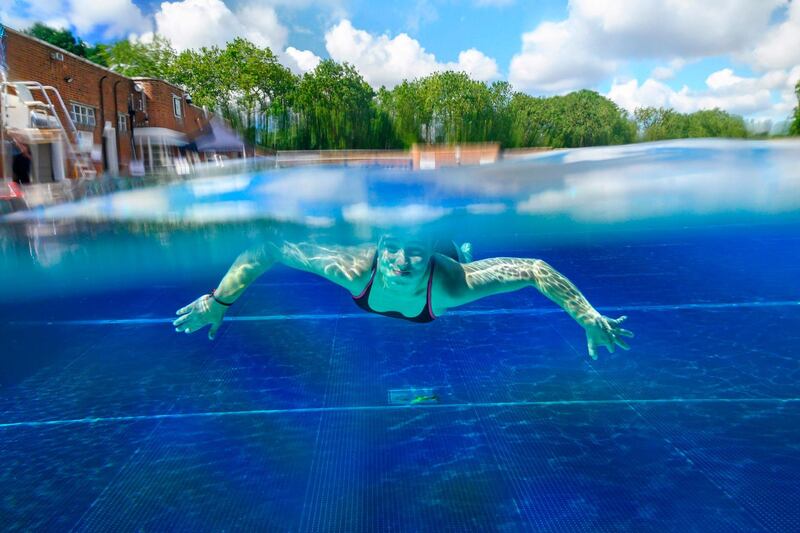 A swimmer moves under the water at Parliament Hill Lido in London, as restrictions are further eased during the coronavirus pandemic.  AFP