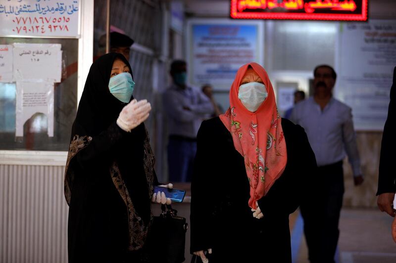 Iraqi women who have recovered from the coronavirus wear protective face masks as they leave the quarantine hospital, following the outbreak of the virus, in Baghdad, Iraq March 9, 2020. Reuters